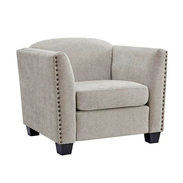 Light grey fabric armchair with nailhead trim and wooden legs