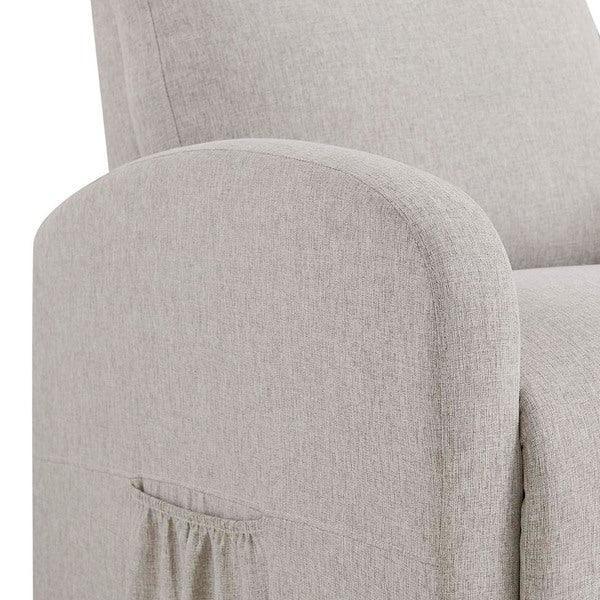 Light grey fabric armchair detail with curved armrest and side pocket feature