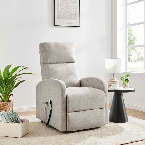 Light grey fabric recliner chair in modern living room with side table and plant