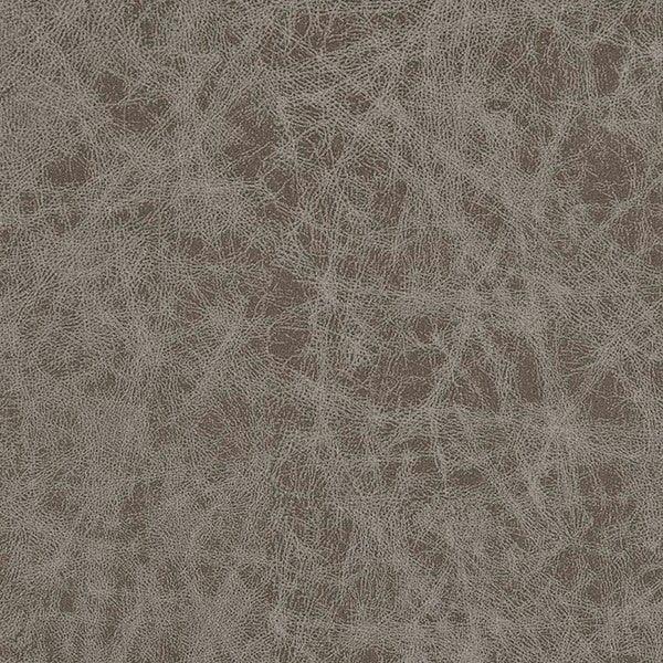 Closeup of brown leather sofa upholstery with textured grain pattern