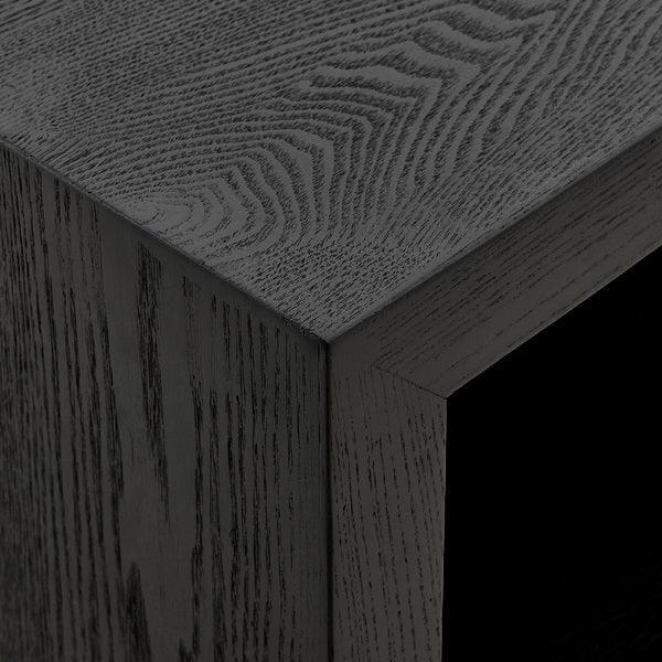 Close-up of black wood grain corner on modern furniture cabinet