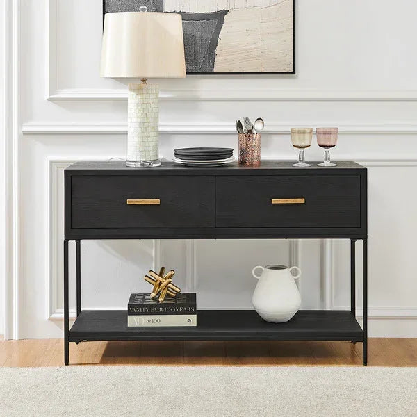 Black console table with gold handles, decorative items and lamp in modern living room setting