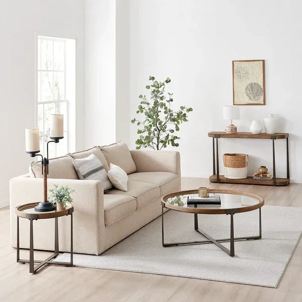 Neutral living room with beige sofa, round glass coffee table, metal frame side table, console table