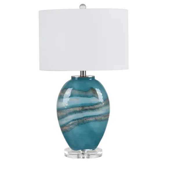 Blue ceramic table lamp with white drum shade and chrome base
