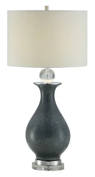 Grey ceramic table lamp with glass detail and white drum shade on chrome base