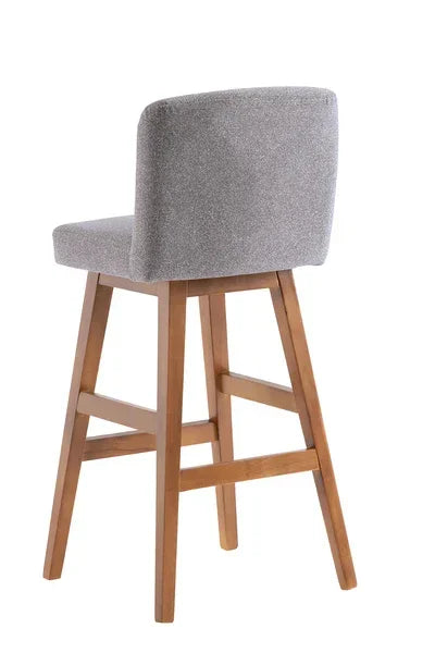 Grey fabric bar stool with wooden legs and low backrest, angled rear view