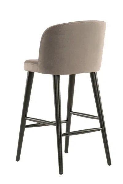 Grey upholstered bar stool with black metal legs shown from rear angle