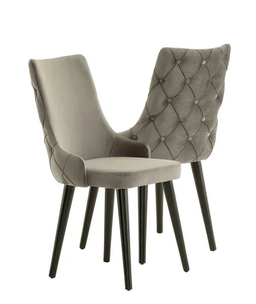 Grey velvet dining chairs with black legs and tufted back design