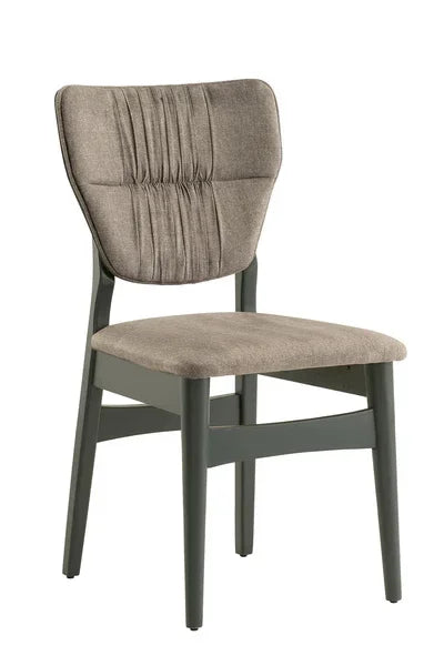 Upholstered dining chair with ruched backrest and grey wooden legs, angled side view