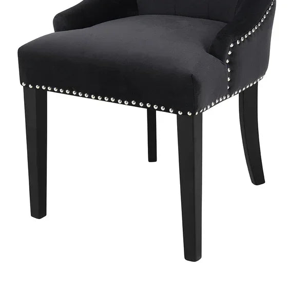 Black dining chair with velvet upholstery and silver stud detailing, straight black legs