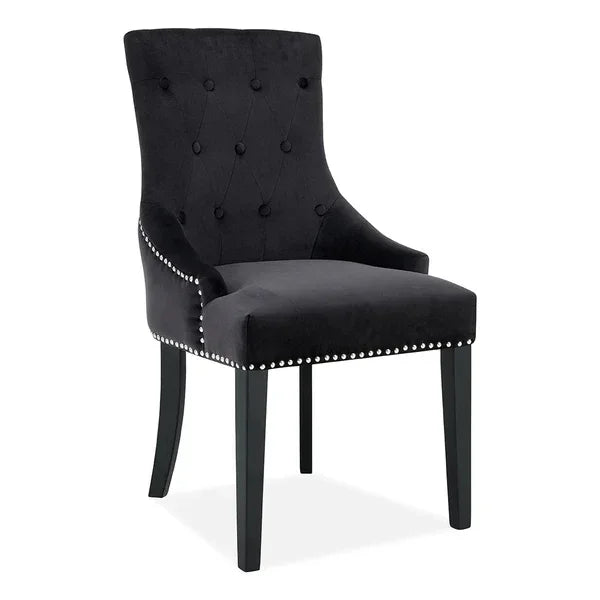 Black velvet dining chair with button-tufted back and nailhead trim, front view