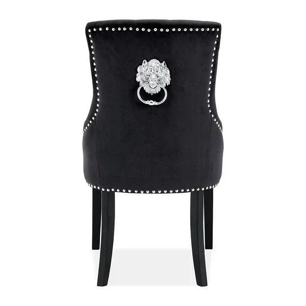 Black velvet dining chair with silver lion head knocker and studded trim, rear view