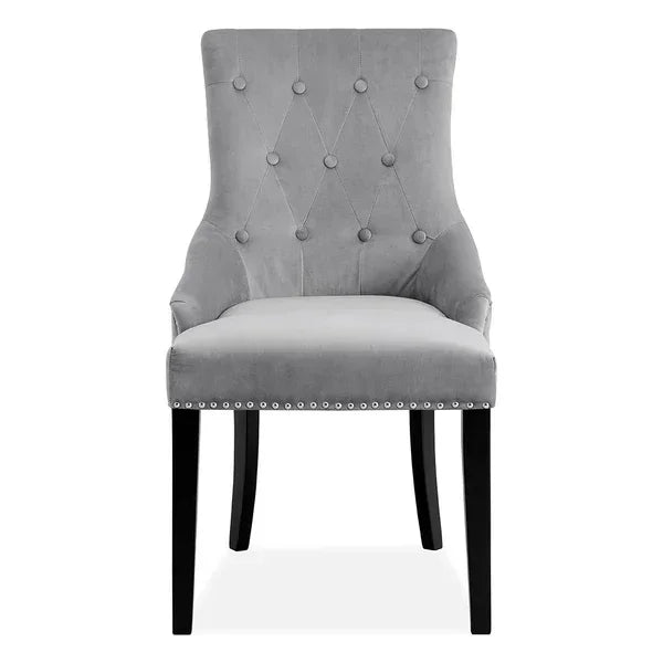 Grey velvet dining chair with button-tufted backrest and silver stud detailing, front view