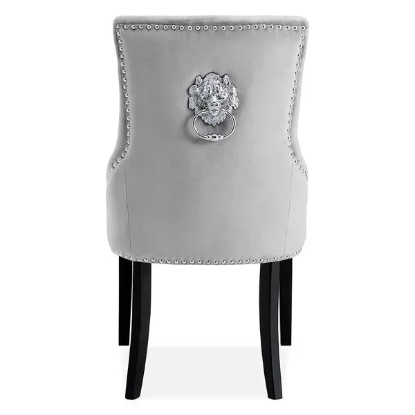 Grey velvet dining chair with lion head knocker and silver stud detail, rear view