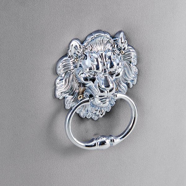 Silver lion head ring handle on grey upholstered furniture