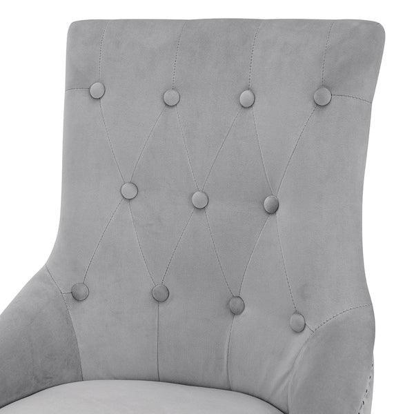 Light grey velvet dining chair with button tufted backrest close-up