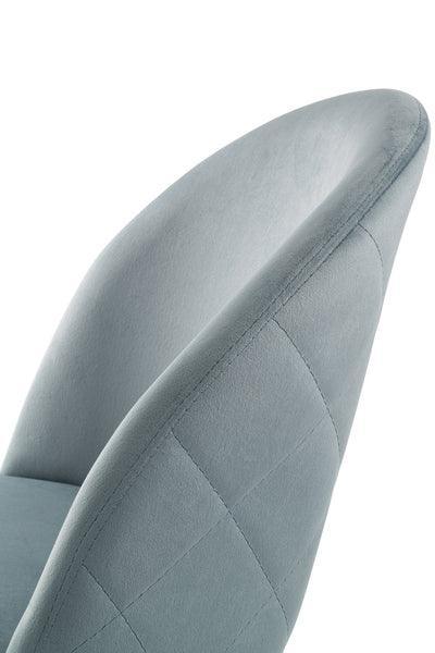 Close up of grey upholstered dining chair with curved back and stitched detailing