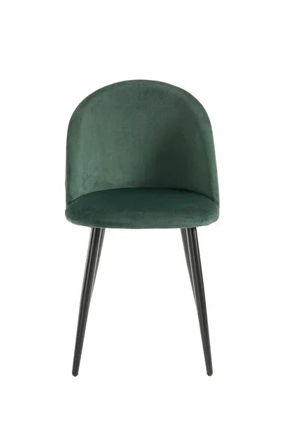Green velvet dining chair with curved backrest and black metal legs, front view