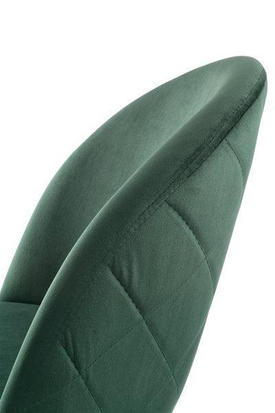 Green velvet dining chair with curved backrest and quilted stitching detail