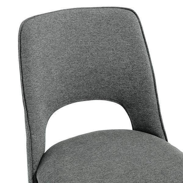 Grey fabric dining chair with curved backrest and cut-out design, close-up view
