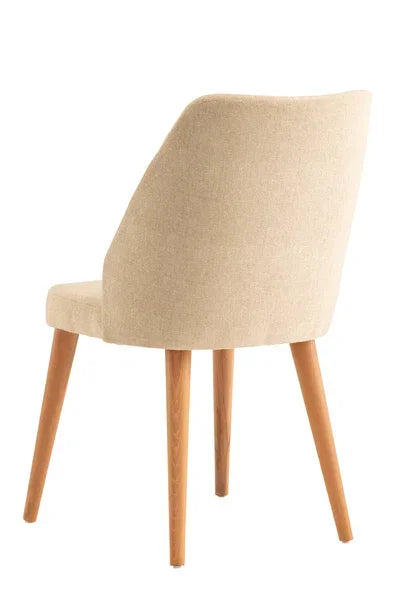 Beige upholstered dining chair with curved backrest and wooden legs, rear angle view