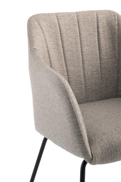 Beige fabric dining chair with black metal legs and curved backrest, close-up front view