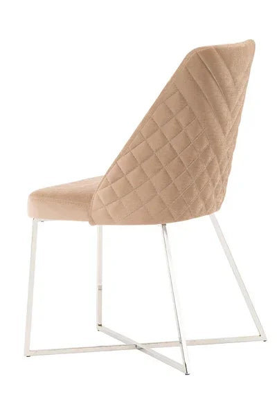 Beige velvet dining chair with quilted back and chrome legs, rear angled view