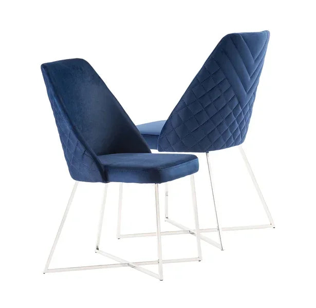 Set of blue velvet dining chairs with quilted backs and chrome legs