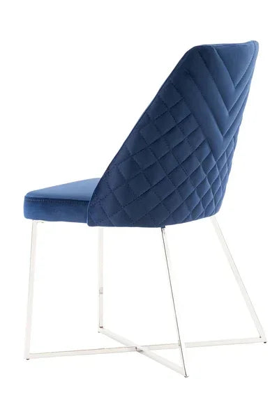 Blue velvet dining chair with quilted backrest and chrome metal sled legs, rear view