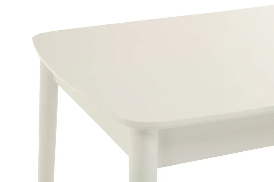 White dining table corner with rounded edges and smooth finish