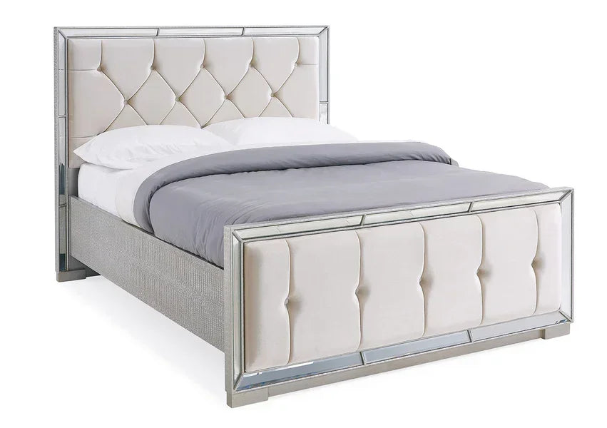 Upholstered bed with mirrored frame, diamond tufted headboard and footboard, angled view