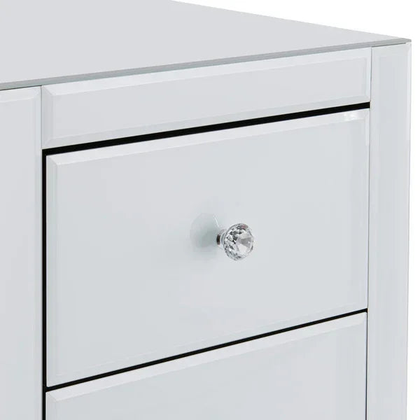 Gloss white chest of drawers with crystal handle and reflective finish, close-up view