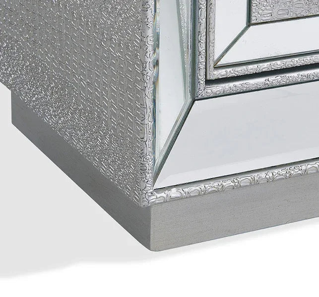 Mirrored bedside table corner with embossed silver detailing and wood base