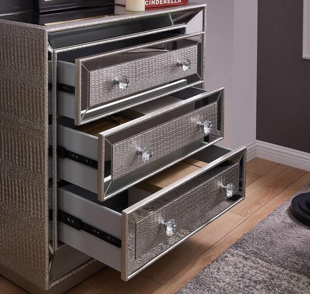 Silver mirrored chest of drawers with textured finish and crystal handles on wood floor