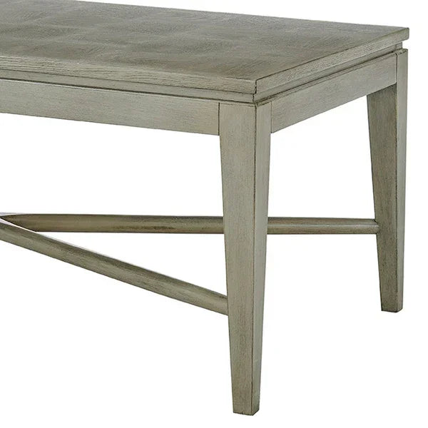 Light wood dining table with rectangular top and angled legs, corner view