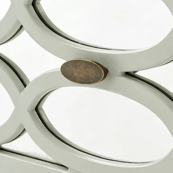 Closeup of metal furniture frame with oval bronze decorative accent