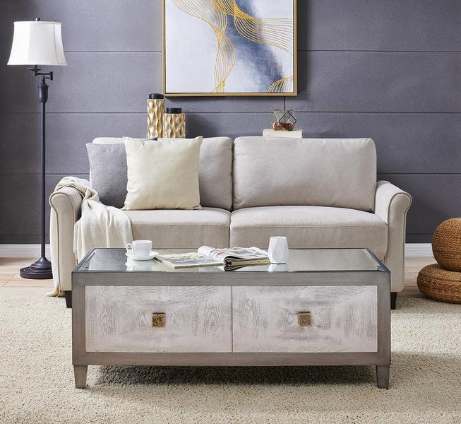 Light grey sofa with cream cushions and a glass top coffee table in modern living room