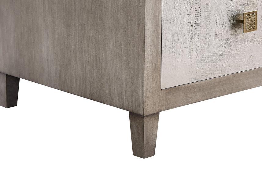 Light wood cabinet corner with angled legs and textured drawer front