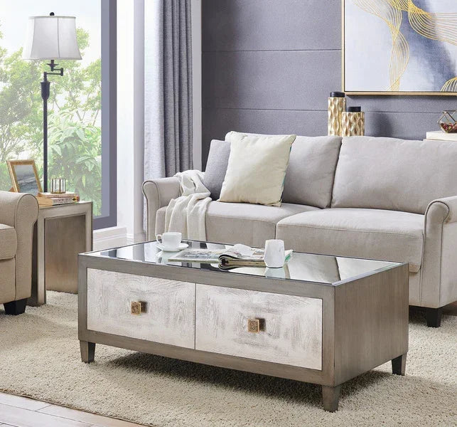 Light grey fabric sofa with plush cushions beside glass top coffee table in modern living room