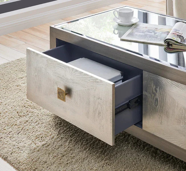 Glass top coffee table with storage drawer open on beige rug