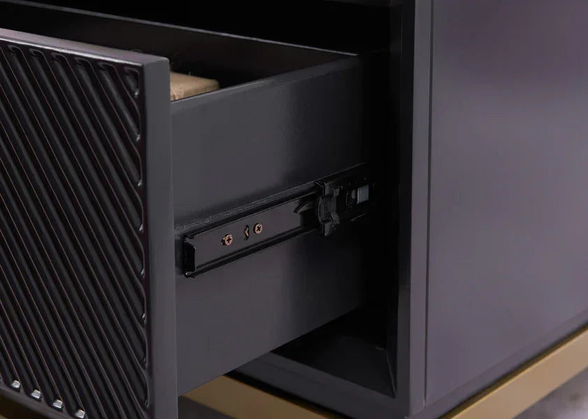 Black wooden furniture drawer with textured front and metal runners in close detail
