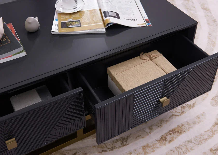 Black coffee table with geometric drawers, storage boxes inside, magazines on top surface