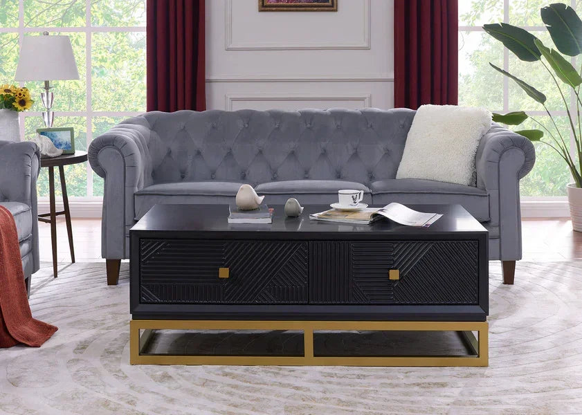 Grey tufted sofa with black coffee table featuring gold base in modern living room