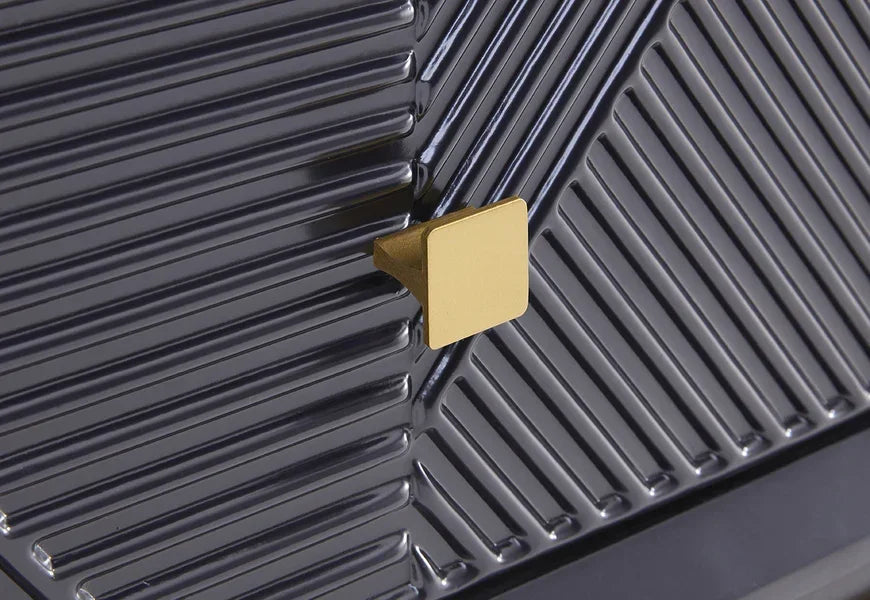 Textured black cabinet door with gold square handle and chevron pattern detailing