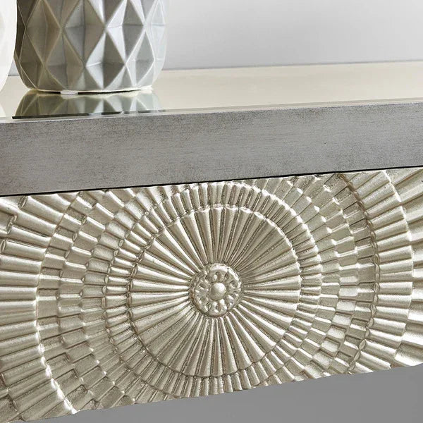 Silver embossed drawer front with geometric vase on mirrored console table