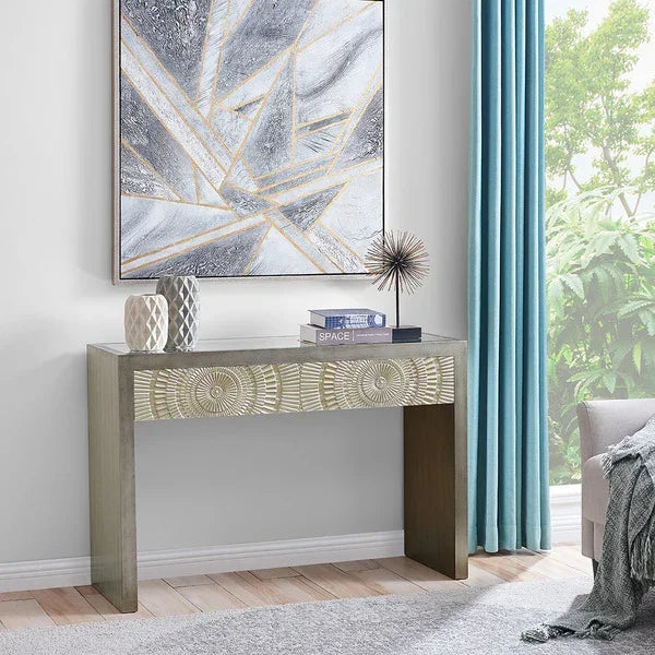 Wooden console table with carved front, geometric decor, under abstract wall art in living room