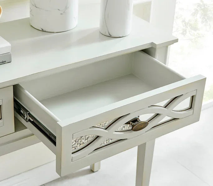 White wooden console table with decorative drawer front and open storage drawer