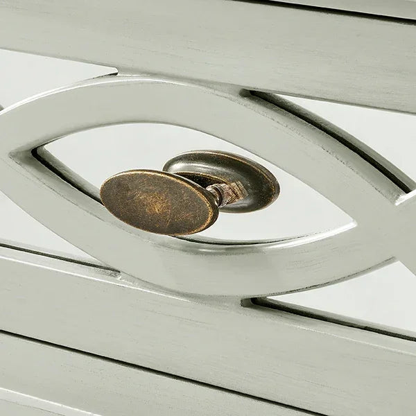 Brushed metal furniture handle on white painted wood with geometric cut-out design