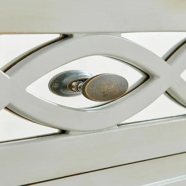 Brushed metal knob on white wooden furniture with lattice detail