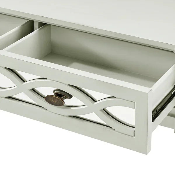 White wood drawer with decorative cut-out front and bronze knob, close-up view